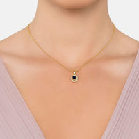 Gold-tone pendant necklace with blue sapphire-style stone in a small bezel