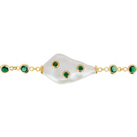 Gold bracelet with white pearl centerpiece, emerald green stone clusters, and clasp