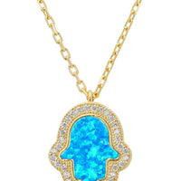 Gold hamsa pendant necklace with blue opalite center and clear stone border