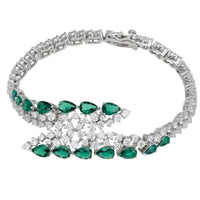 Silver tennis bracelet with emerald green oval stones and prong settings