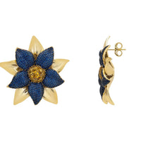 Blue daisy flower stud earrings with gold-tone backing and post detail.