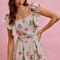 Ivory floral romper with cut-out waist and ruffled sleeves, pink rose print