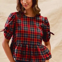 Red plaid peplum top with ribbon-tied short puff sleeves and gathered waist