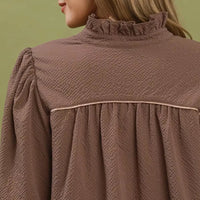 Chocolate textured mini dress close-up: ruffled collar and pleated back yoke