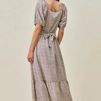 Ditsy floral midi dress from back view, puff sleeves and tied self-belt at waist