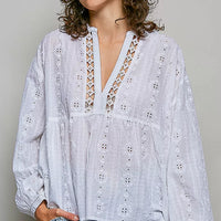 Off-white cotton V-neck blouse with lace trim and long balloon sleeves