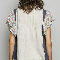 Cream blouse back with vertical seams and floral ruffle sleeves
