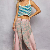Blue crocheted cropped cami with scalloped hem and thin straps, front view