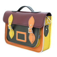 Handmade leather satchel side view, plum flap, teal front panel, yellow side strap