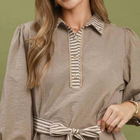 Close-up of brown striped contrast mini dress neckline and bow tie belt