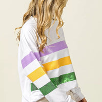 Off-white sweatshirt with sequined purple, yellow, and green striped sleeves and back