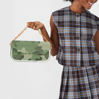 Green camouflage shoulder bag held by white strap, gold chain detail and flap front.