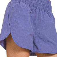 Light blue running shorts with elastic smocked waist and side hem vents