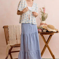 Ivory blouse top with blue shell print and ribbon tie at center front