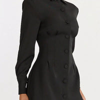Black fitted blazer mini dress with notched collar and long sleeves, button front detail.