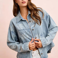 Light blue denim jacket, button-front with white floral print and front pockets