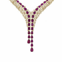 Gold-tone statement necklace with marquise ruby red gemstones and V-drop center
