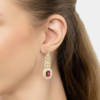 Gold-tone drop earrings with ruby-red oval center and clear stone surround