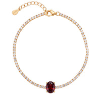 Gold tennis bracelet with oval ruby gemstone center and pavΓ©-style stones