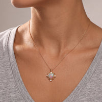 Gold opal-look heart pendant necklace on a model, worn on the neckline