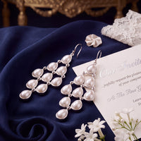 Silver-tone pearl teardrop chandelier earrings, pair shown at angle