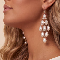 Silver-tone pearl teardrop chandelier earring with cascading drops, close-up