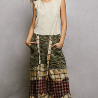 Beige ribbed tank top with lace trim at neckline and armholes