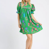 Green floral V-neck dress with puff sleeves and gathered waist, above-knee length
