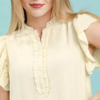 Cream henley neckline with button placket and ruffle sleeves on shift dress