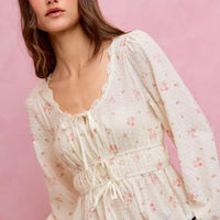 White floral clip-dot peplum blouse with lace-trim neckline and ruched drawstring bodice