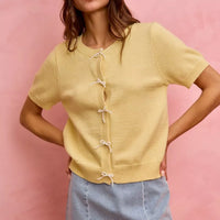 Light blue denim mini skirt with lace ribbon bow trim and frayed hem edge.
