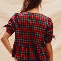 Back view red plaid peplum top with ribbon-tied short puff sleeves