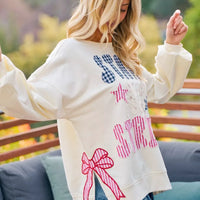 Cream crewneck sweatshirt with stars-and-stripes patch-style graphic, long sleeves