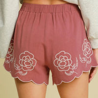 Dusty pink linen-blend shorts with floral embroidery, elastic waist, scalloped trim