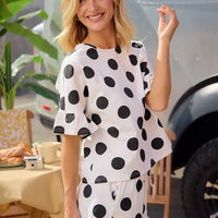 Ivory-and-black polka dot top and shorts set with ruffled hem detail