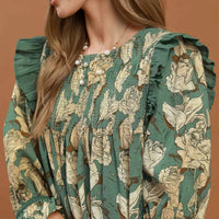Sage floral smocked ruffle dress close-up with puff sleeves and detailed smocking