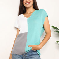 Turquoise and white color-block V-neck knit top with short sleeves and knit texture.