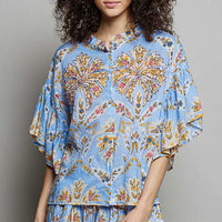 Blue floral printed woven ruffle-sleeve shirt with elastic waist, close front view