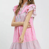 Pink and striped tiered dress with flutter sleeves and dot skirt, side view