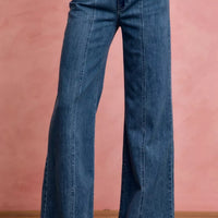 Mid-rise stretch denim jeans, front view showing center seam and flared hem