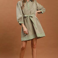 Olive striped mini dress with tie belt, contrast trim, and puff sleeves
