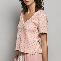 Soft pink floral V-neck T-shirt with scalloped lace neckline and short sleeves