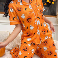 Halloween pajama set: orange short-sleeve button-up shirt with pocket and halloween character prints