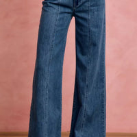 Mid-rise stretch denim jeans, front view with straight waistband and flared legs