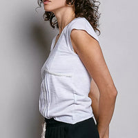 Off-white sleeveless-style textured knit V-neck top with lace-trim neckline