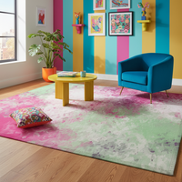 Rectangular abstract pink and green rug with soft splatter-like color texture.