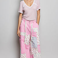 Baby pink textured V-neck short-sleeve T-shirt with white lace trim, front view