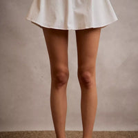 White denim bubble skort with flared hem and smocked back waistband