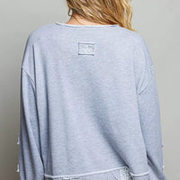 Heather gray V-neck sweatshirt back view with raw hem and small patch detail