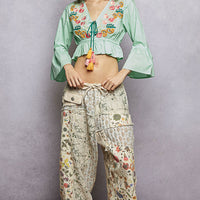 Mint floral embroidered cropped blouse with V-neck and tassel tie at waist